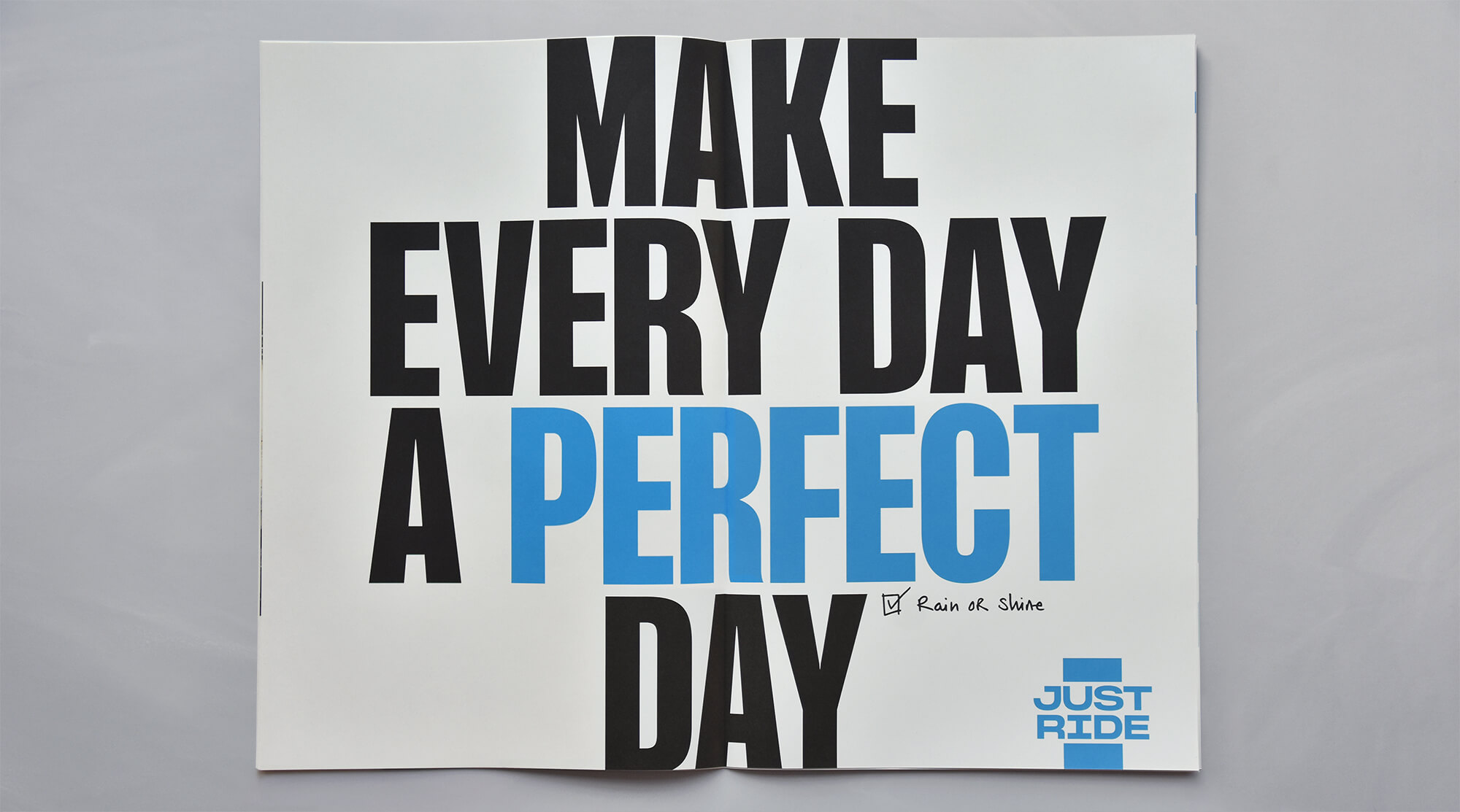 Shimano newspaper spread with the headline 'Make every day a perfect day,' Just Ride logo and handwritten 'Rain or shine' checkmark
