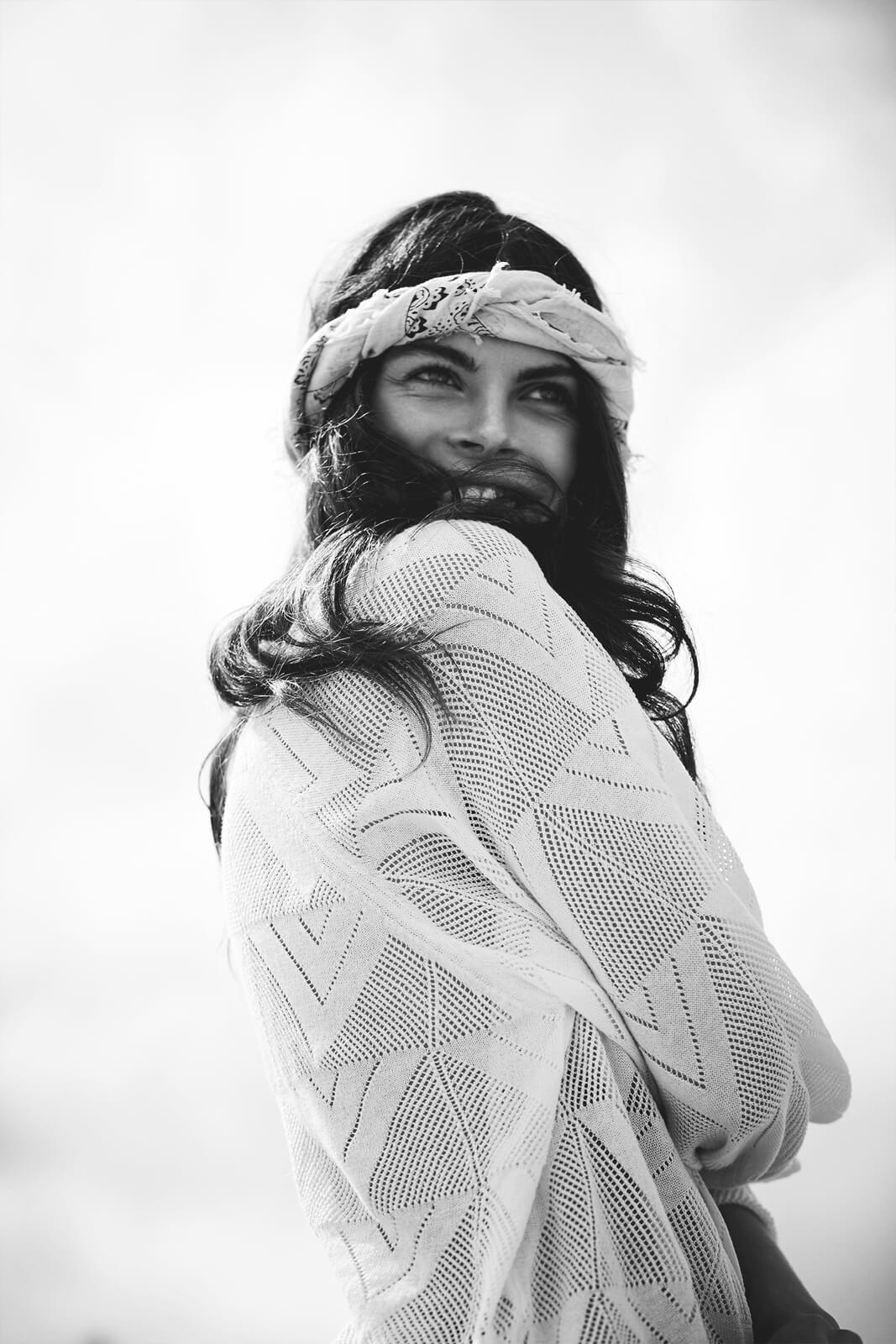 Black-and-white portrait of a woman with a paisley headscarf for COTTONCAKE's April Haze fragrance campaign