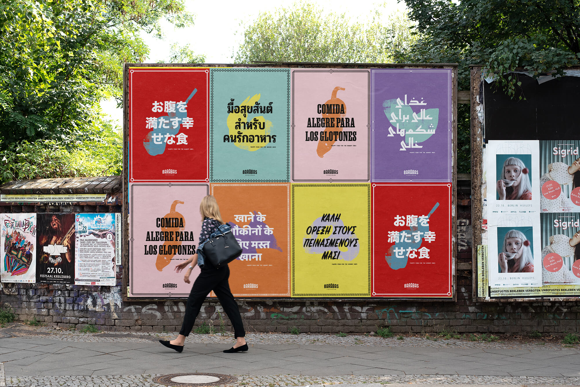 Foodbar Barabas colourful poster wall on a city street, part of its street food campaign. Each poster shows an iconic cultural dish