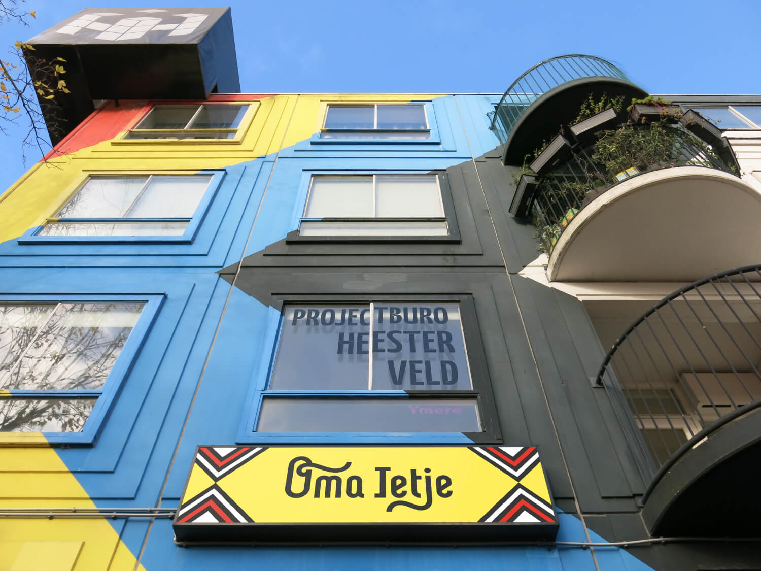 Brand Identity – Oma Ietje | Amsterdam, colourful facade on Heesterveld in the Bijlmer, featuring the logo sign
